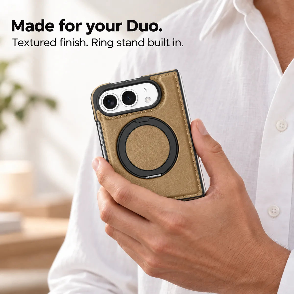 Hand holding a textured synthetic leather folding phone case with the ring stand folded flat. #color_Desert Gold