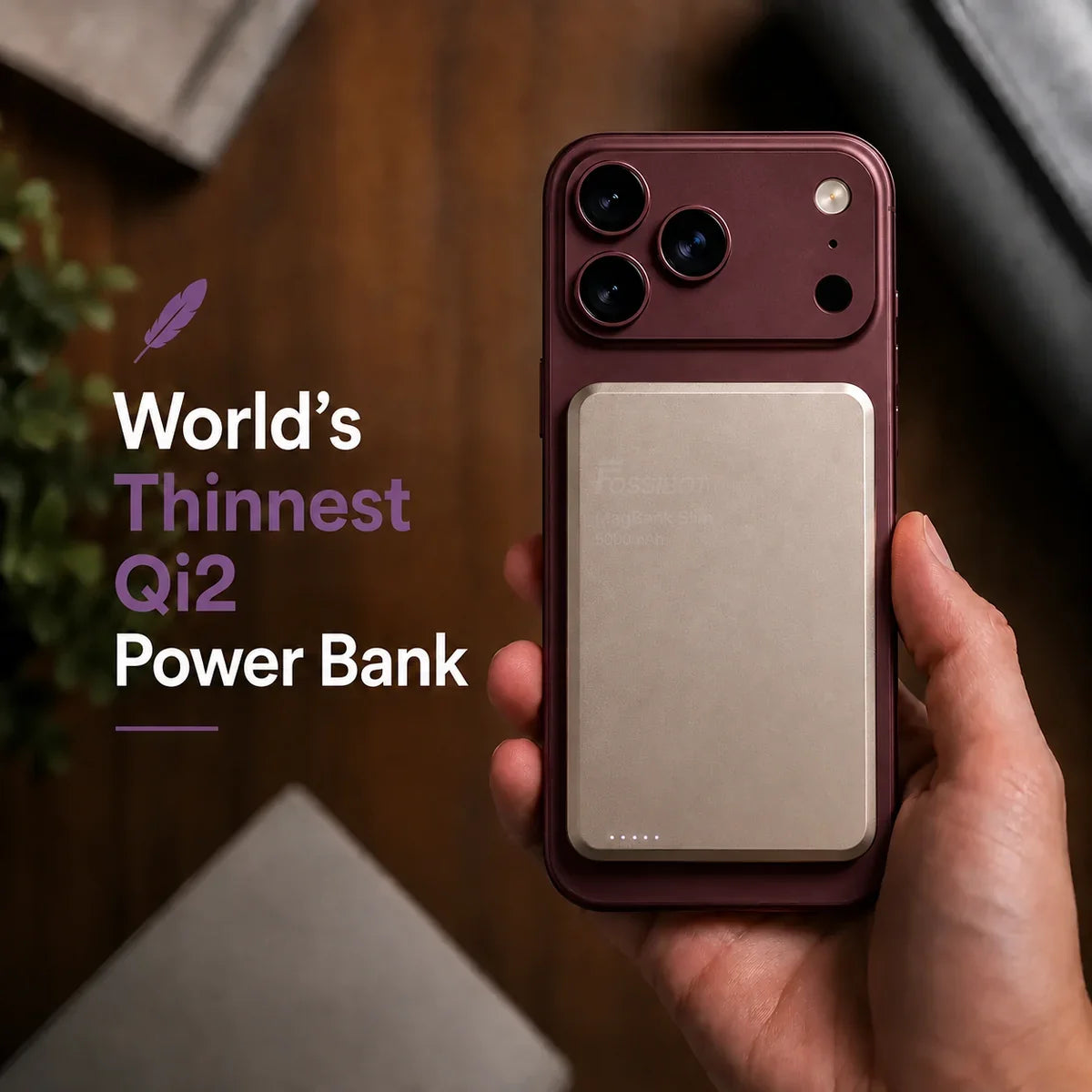 Titanium Stone Gray slim magnetic power bank held on a Burgundy phone. #color_Titanium Stone Gray