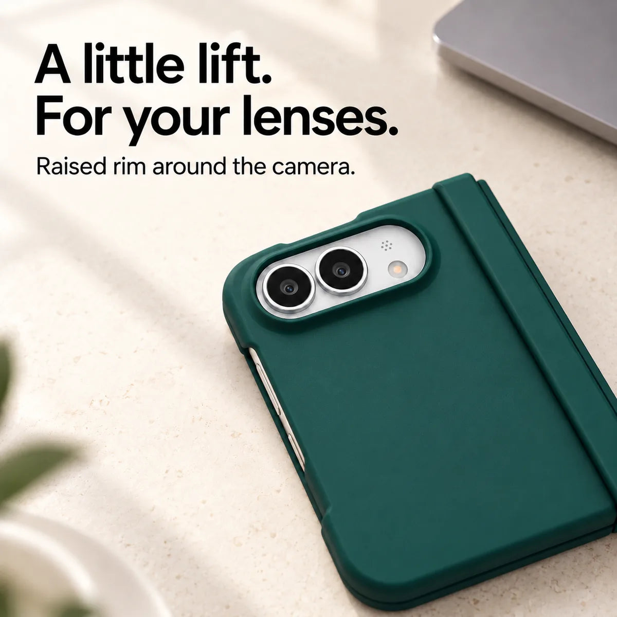 Close-up of the raised Army Green camera rim on a matte iPhone Ultra case resting on a light desk. #color_Alpine Green