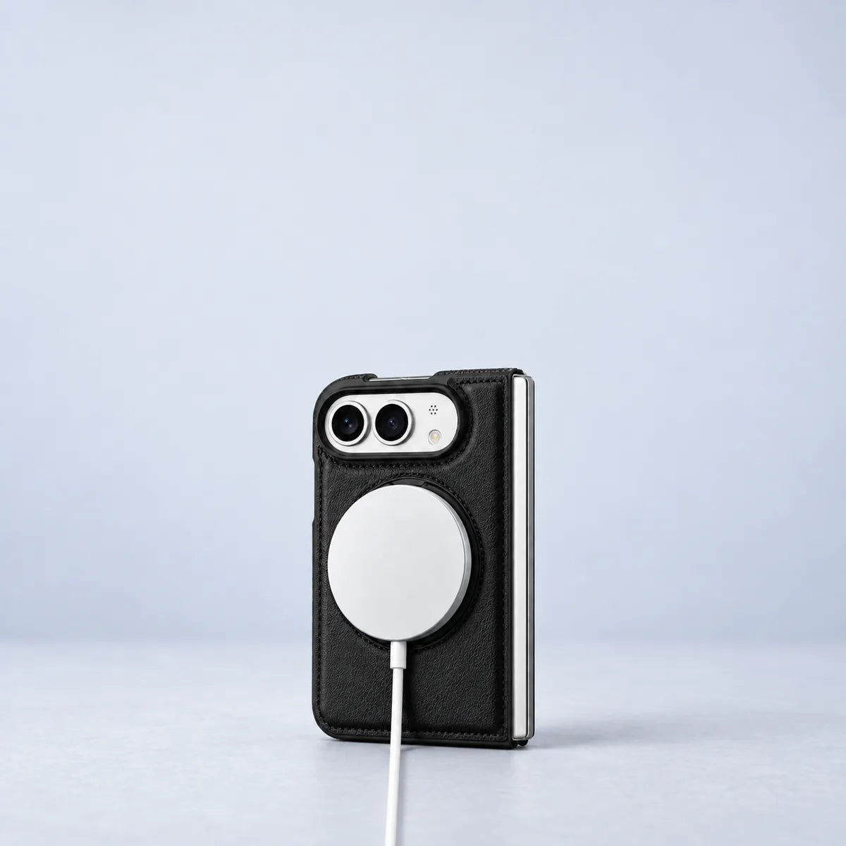 White magnetic charging puck attached to the back of a black PU leather folding phone case.