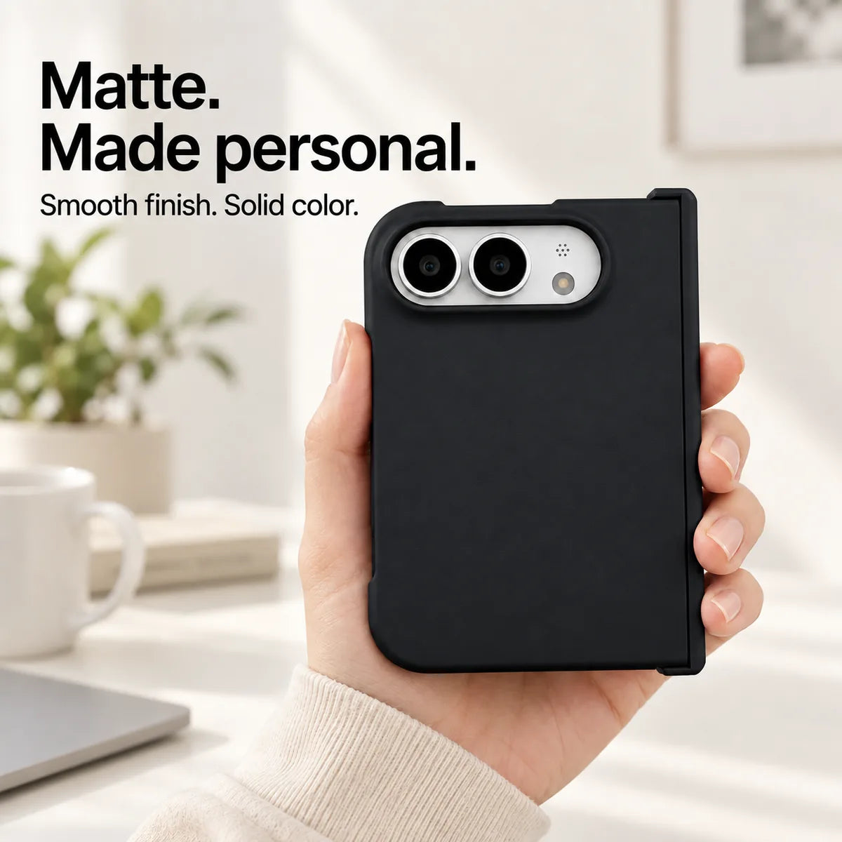Black matte iPhone Ultra case held in one hand, with a smooth solid-color rear shell and silver camera area. #color_Onyx Black