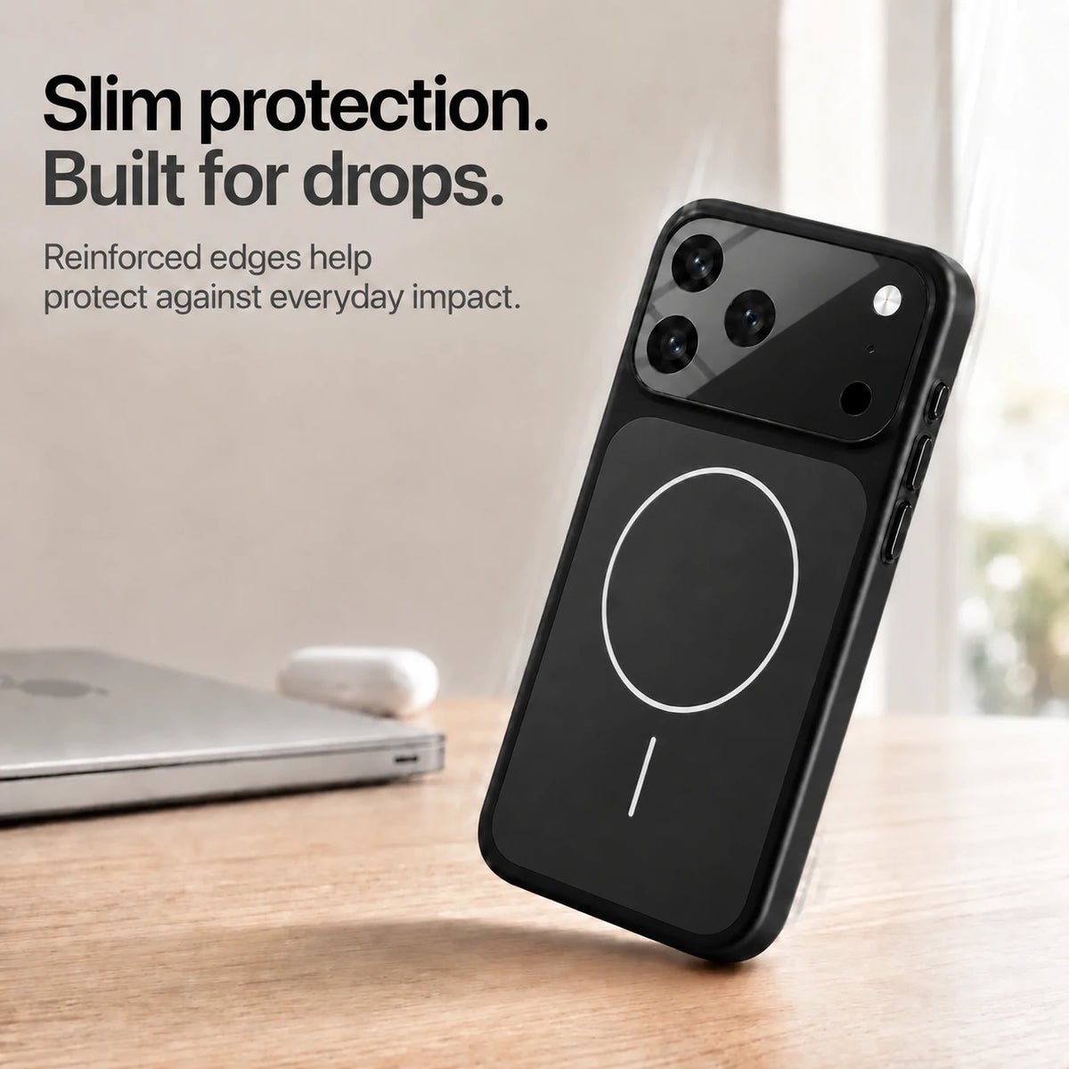 Black slim phone case leaning on one corner on a wooden desk, showing reinforced edges #color_Midnight Black