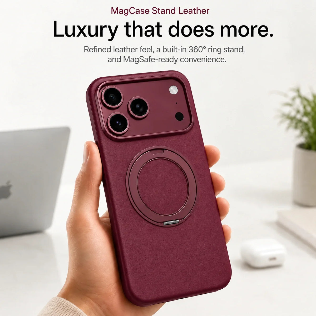 Burgundy leather-finish phone case held at a desk with the ring folded flat #color_Burgundy