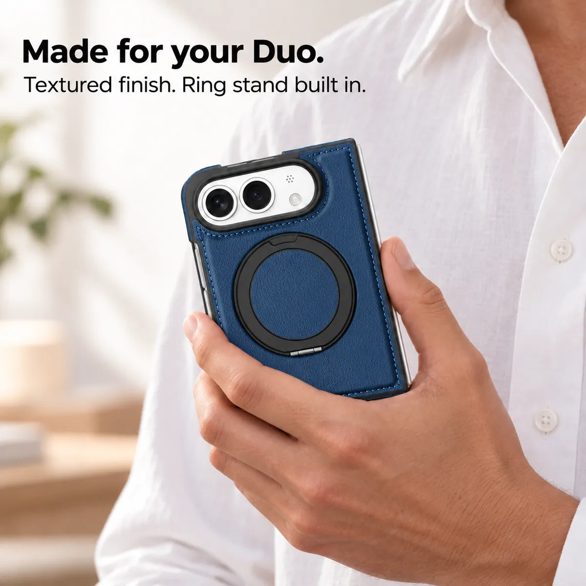 Hand holding a textured synthetic leather folding phone case with the ring stand folded flat. #color_Deep Blue