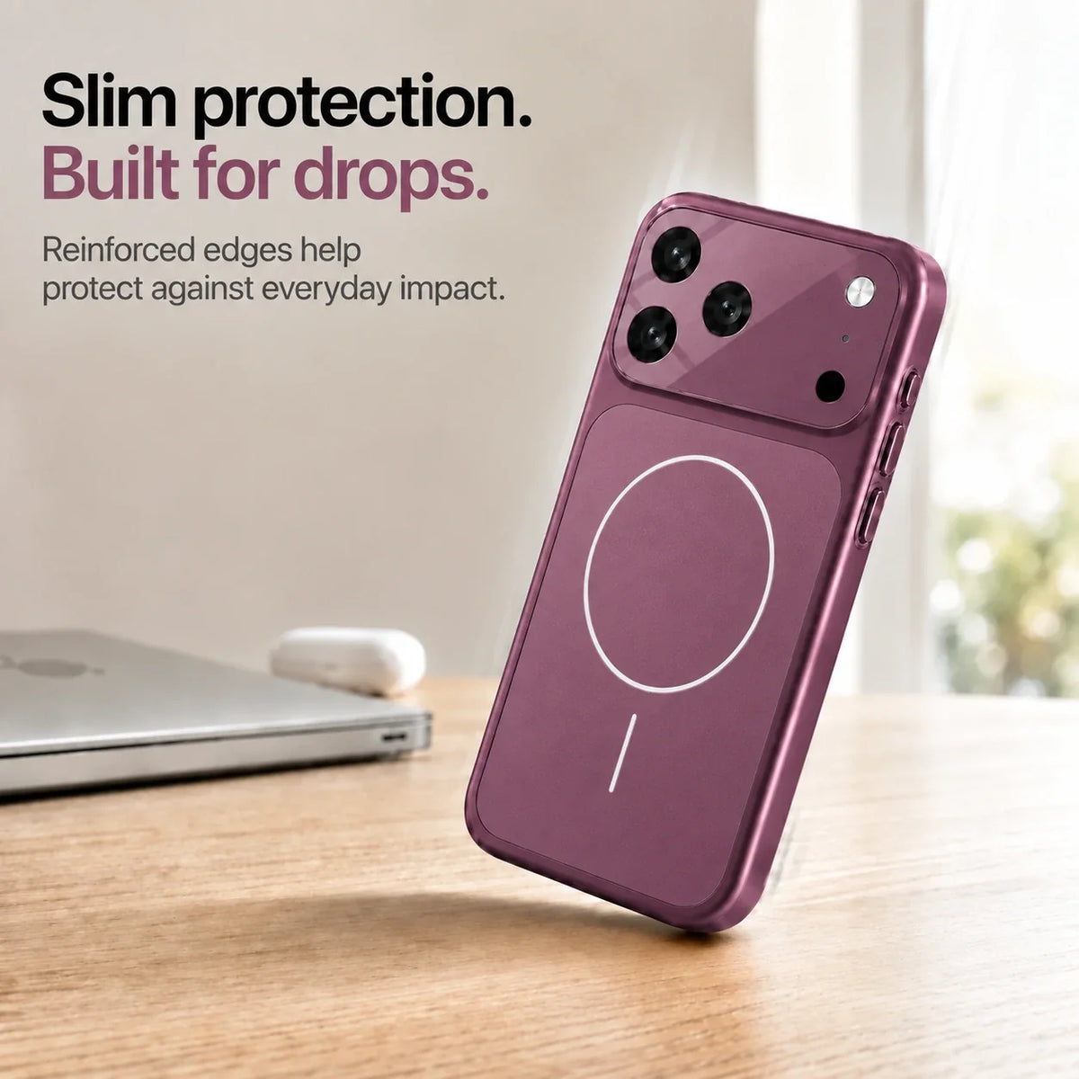 Burgundy slim phone case leaning on one corner on a wooden desk, showing reinforced edges #color_Burgundy
