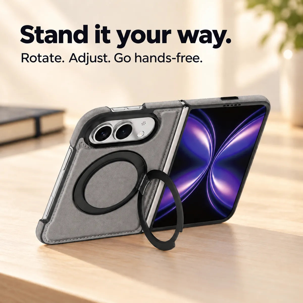 Textured synthetic leather folding phone case with its ring stand deployed on a desk. #color_Titanium Gray