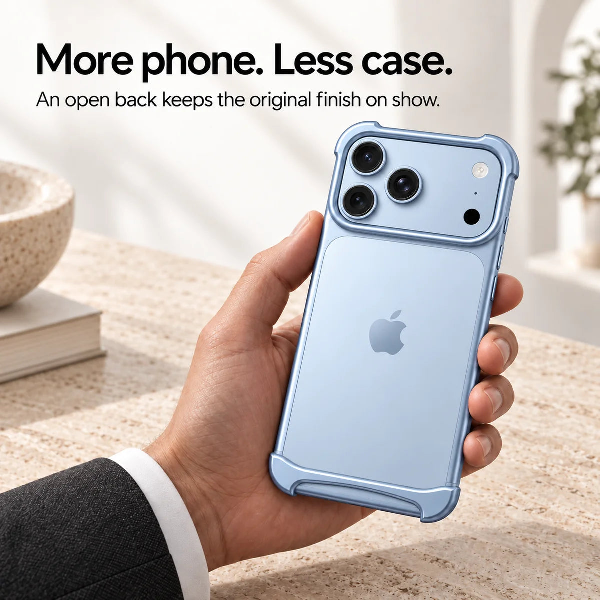 Light blue metal phone bumper held above a pale stone desk, showing the exposed phone back #color_Glacier