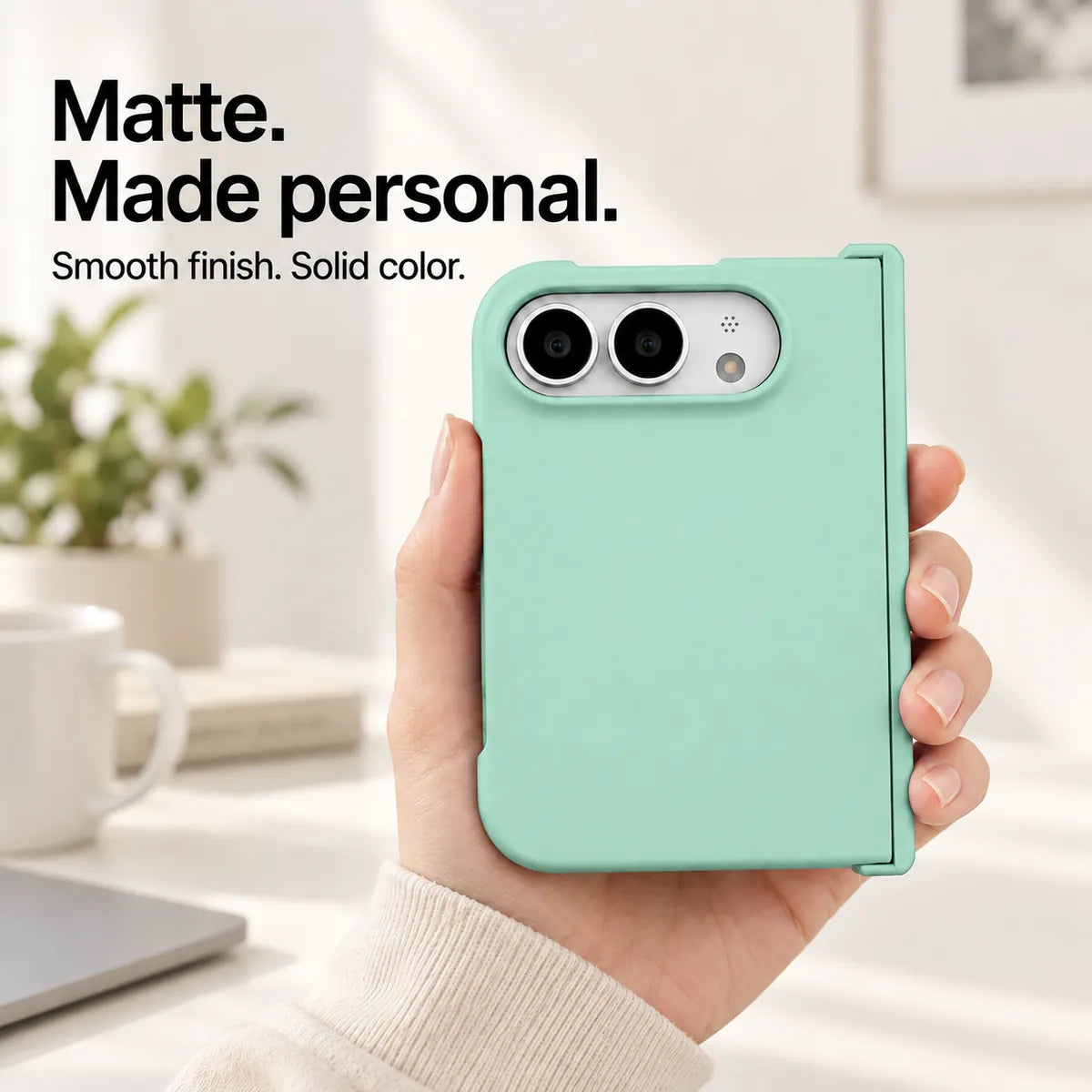 Light Green matte iPhone Ultra case held in one hand, with a smooth solid-color rear shell and silver camera area. #color_Seafoam Green