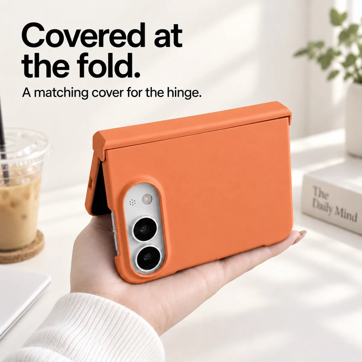 Orange iPhone Ultra case held partly folded, showing the matching cover along the hinge. #color_Sunset Orange