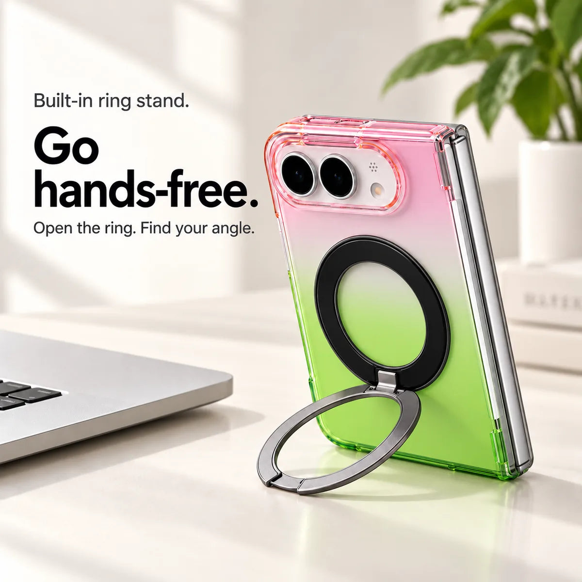 Pink and green gradient case supporting a folded silver phone on a desk with its ring stand open. #color_Aurora Bloom