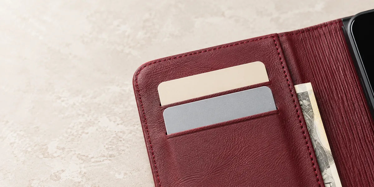 Two card slots and a cash pocket inside the burgundy wallet folio.
